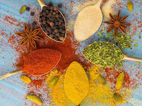 Assorted Indian spices and ingredients in bowls